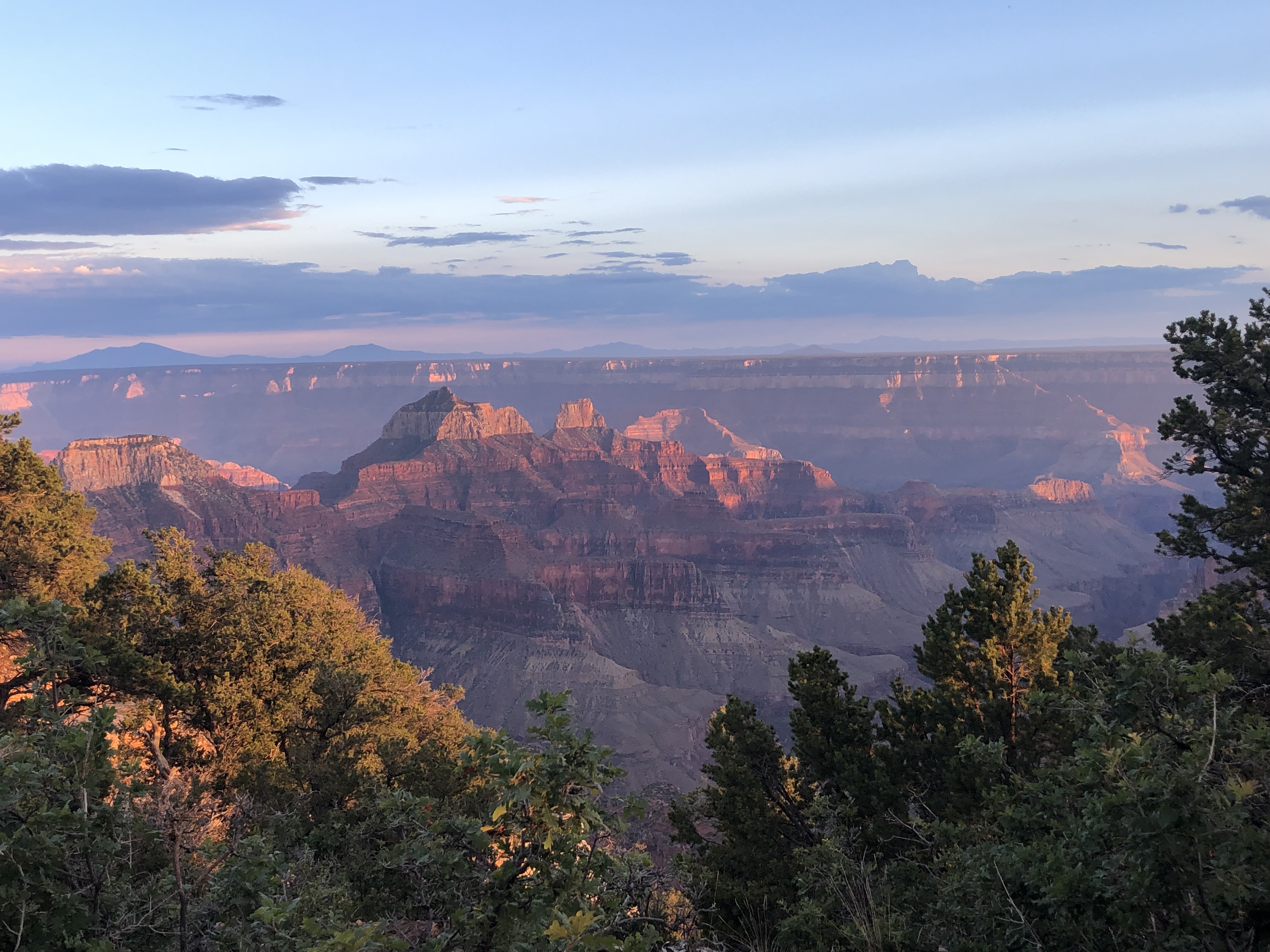 Grand Canyon at sunset, rim and inner buttes lit pink and orange