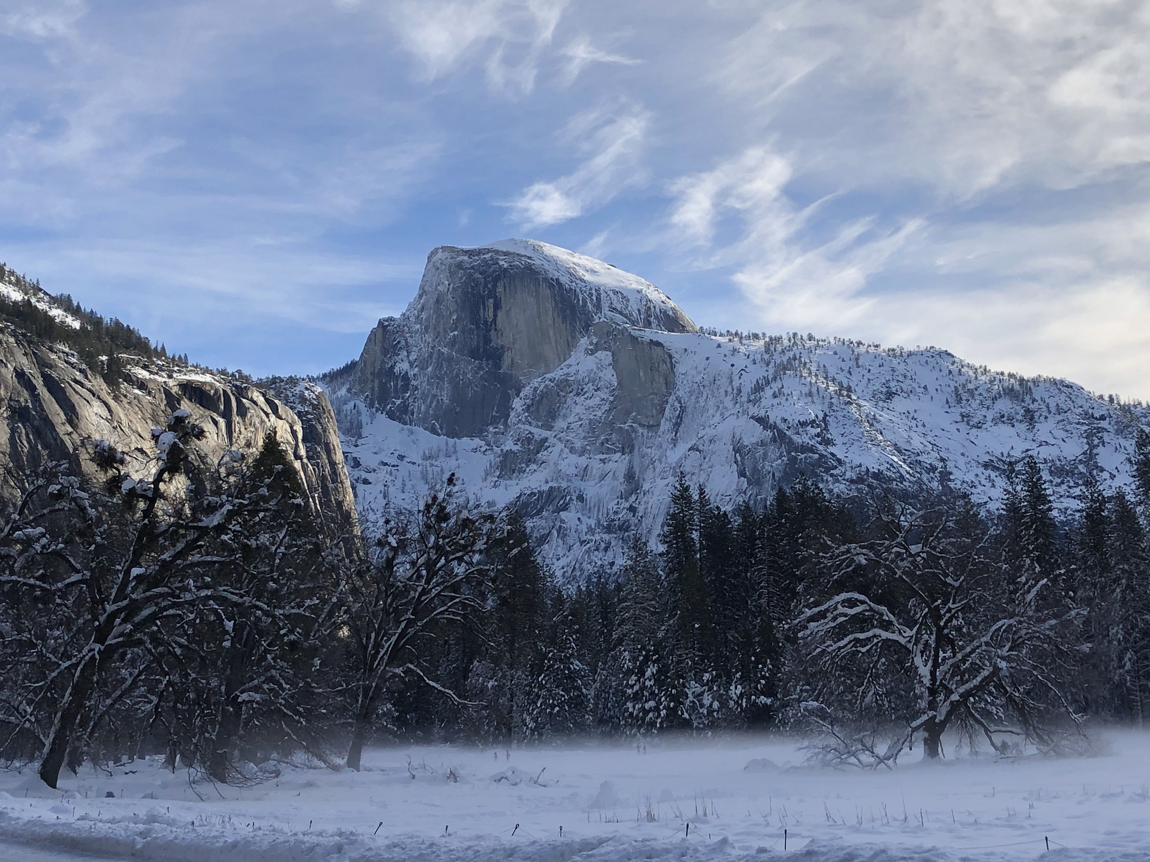 Half Dome rising above a snowy Yosemite Valley